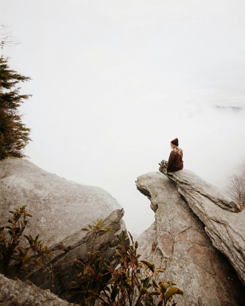 EFT tapping and clarity coaching person meditating in nature at Well Rooted Health