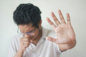 Adult experiencing acid reflux discomfort, illustrating long-term PPI side effects