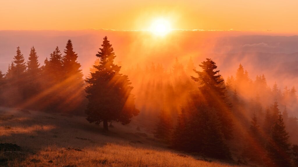 sunrise over mountains representing brain health and mindfulness practice at Well Rooted Health