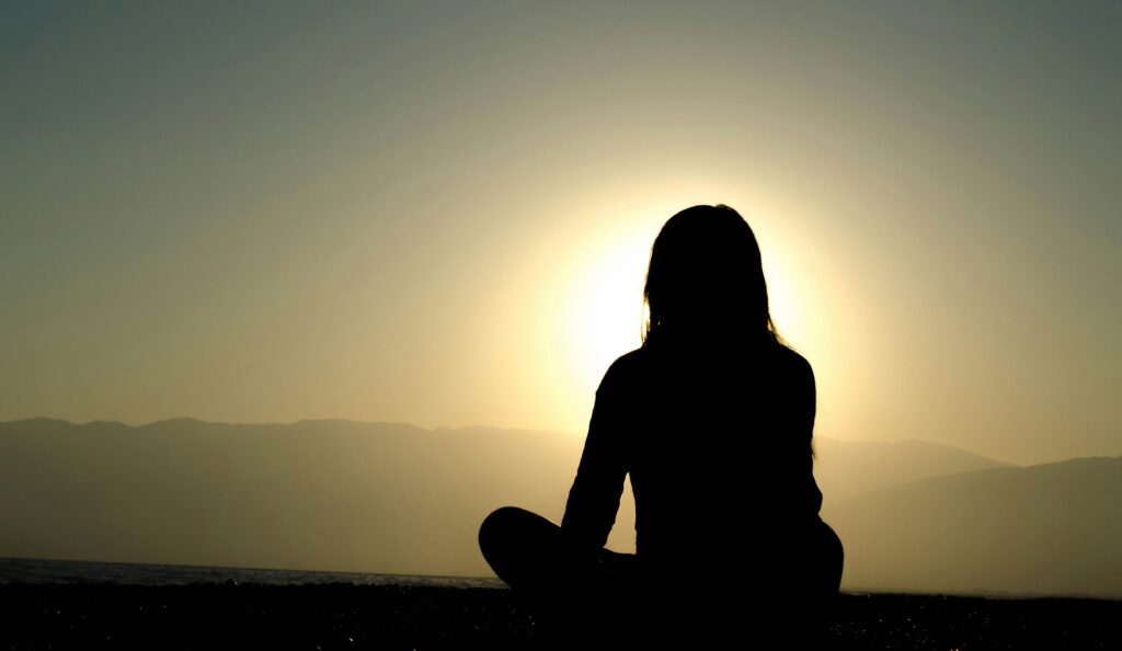 person meditating representing integrative health services and brain health and mindfulness at Well Rooted Health