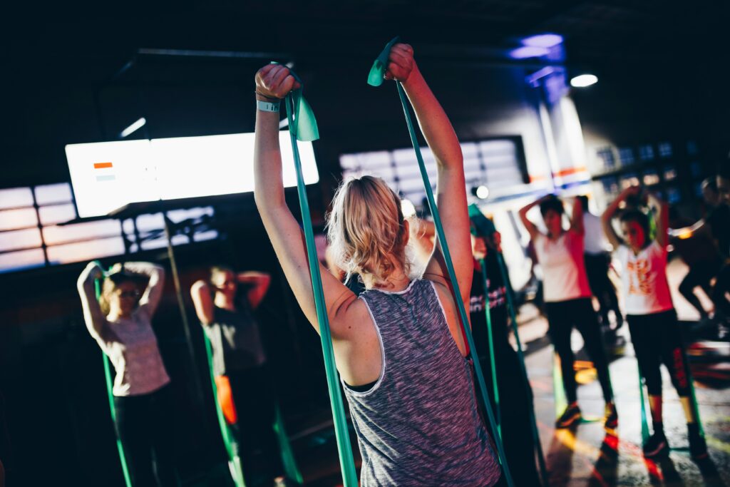 group using resistance bands for posture based exercise and whole body conditioning | Well Rooted Health