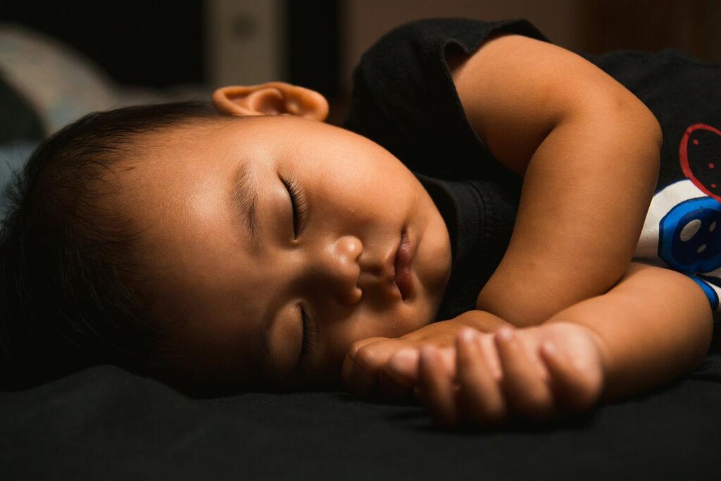 baby sleeping peacefully representing natural sleep optimization and restorative rest | Well Rooted Health