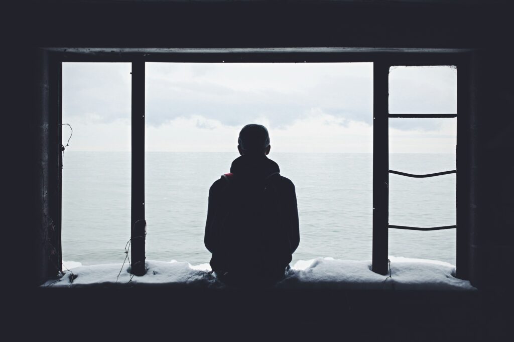 Black and white photo of a person from behind, staring into empty space, reflecting depression as depleted brain energy