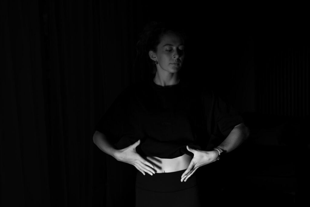 Person practicing diaphragmatic breathing for acid reflux, breathing from the belly