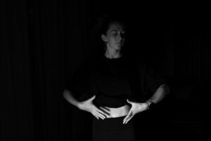Person practicing diaphragmatic breathing for acid reflux, breathing from the belly