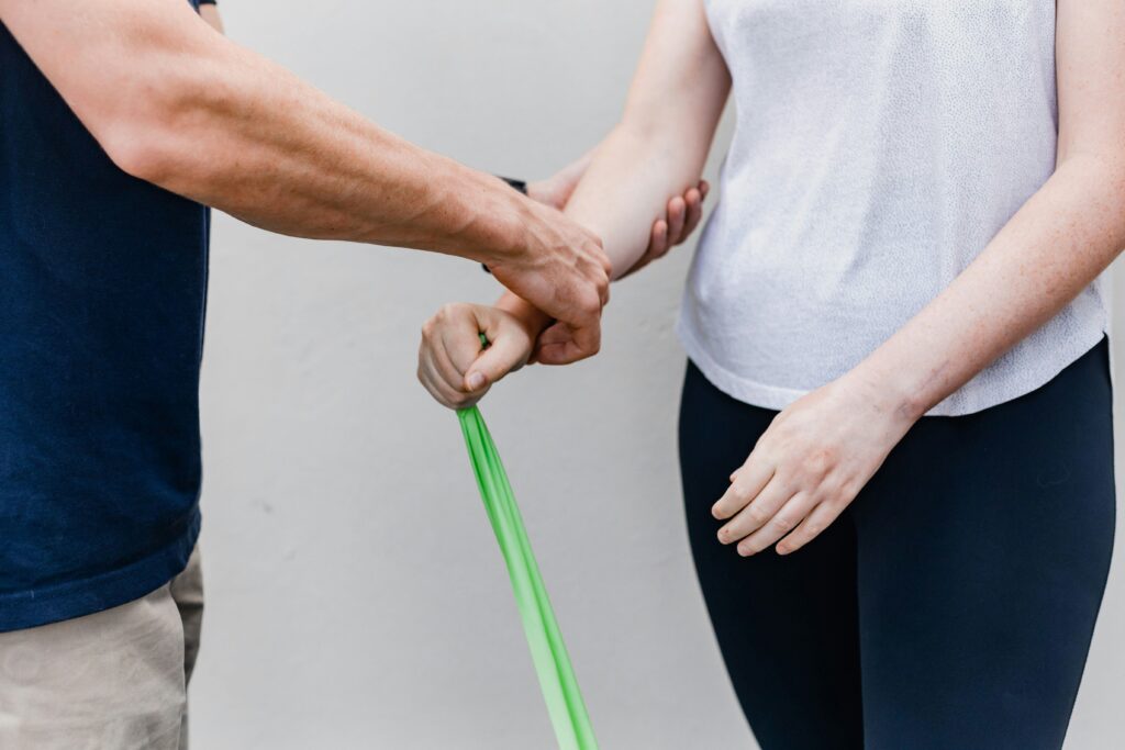 Person learning resistance band technique as part of an osteoporosis exercise program